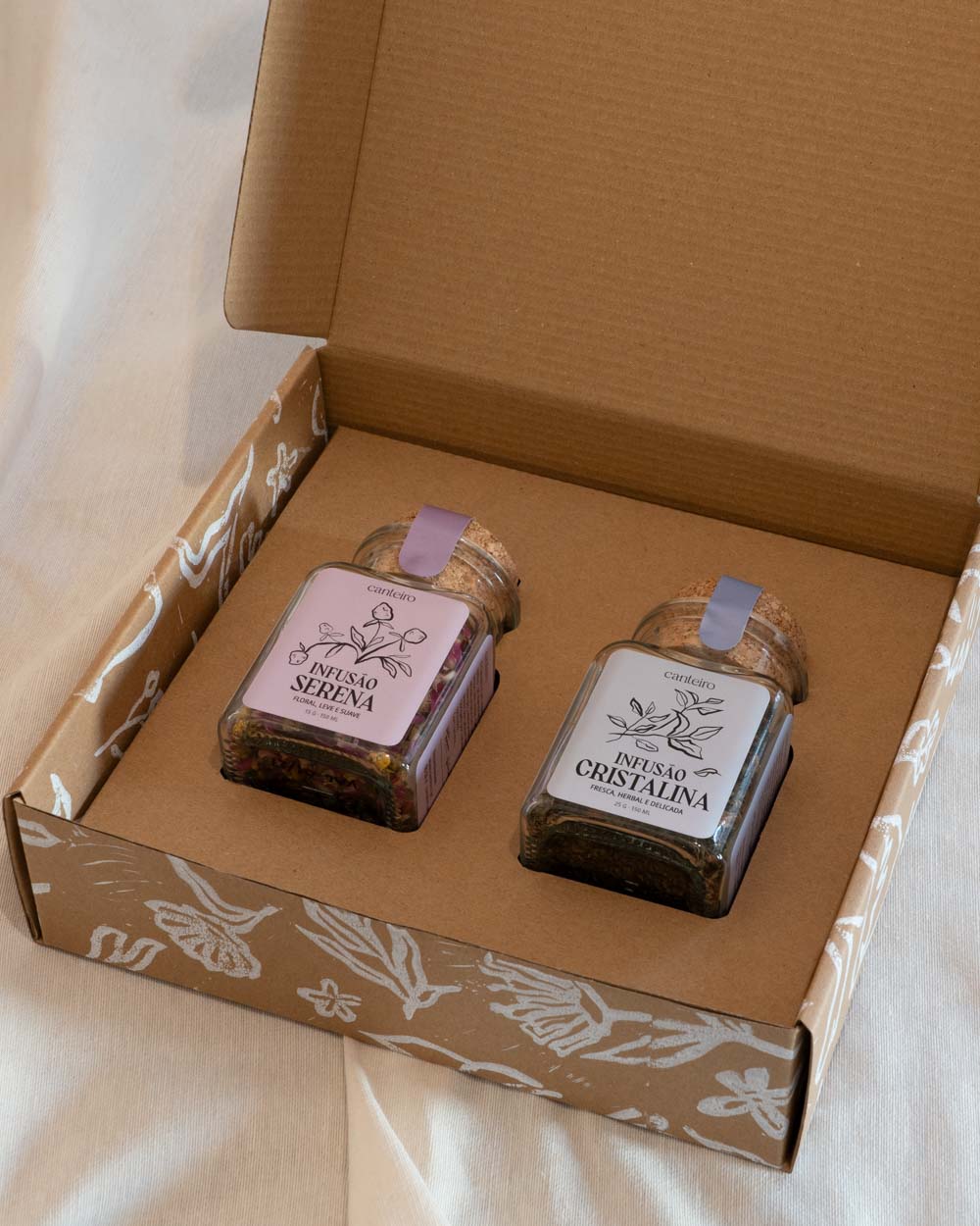 Caixa com conjunto de infusões artesanais em frascos de vidro com tampa de cortiça